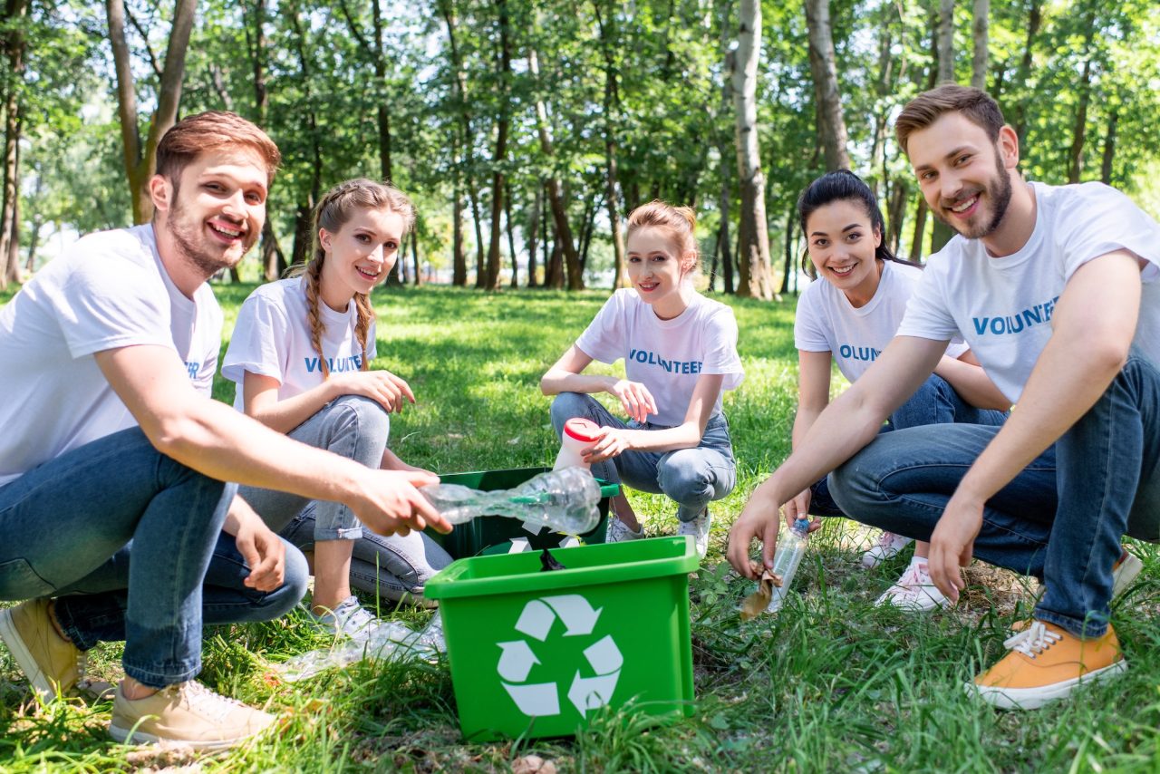 young-volunteers-with-green-recycling-box-cleaning-park.jpg